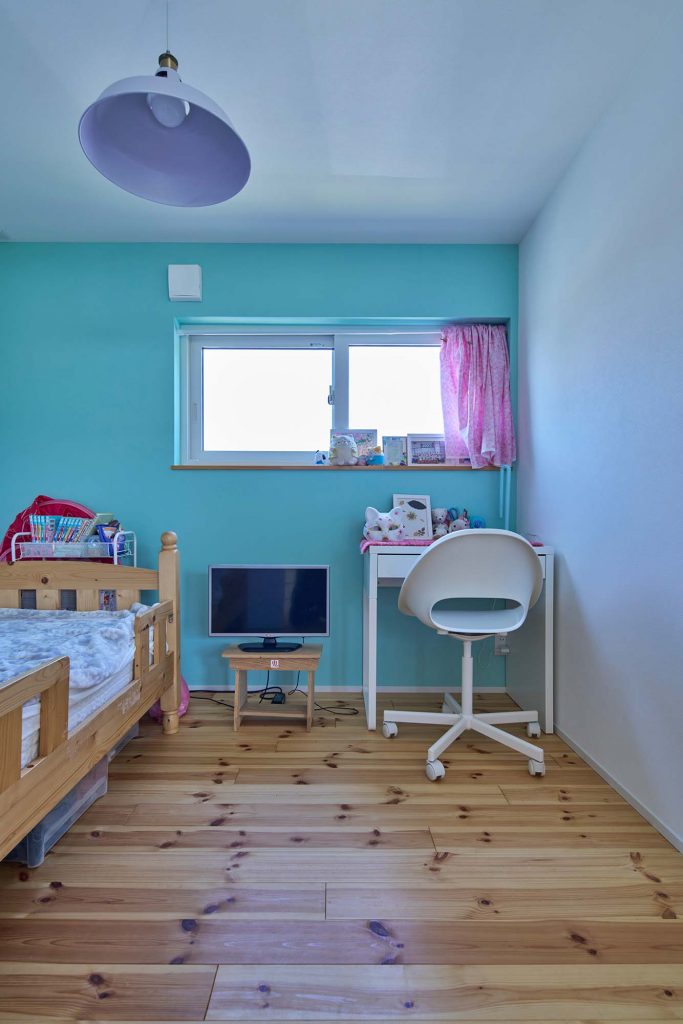 鮮やかなブルーのアクセントウォールが映える子ども部屋。北側にありながら、内装の色の効果で明るく気持ちがいい